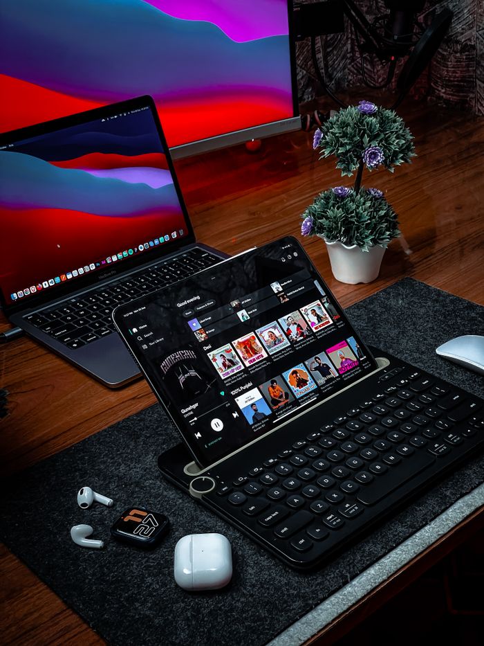 Stylish desk setup featuring Apple devices and tech accessories, perfect for productivity and creativity.